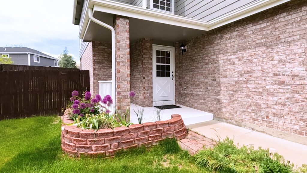 Brick house front with a covered porch and clean brickwork